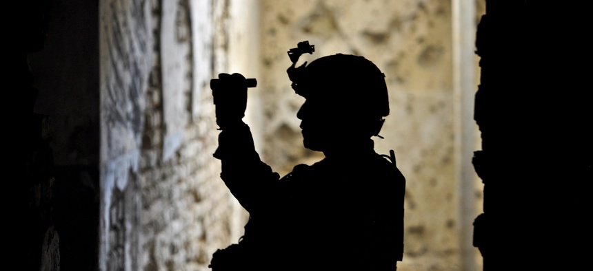 U.S. Army Staff Sgt. Clarence C. Elicio examines a tunnel at Qala-I-Jangi in northern Afghanistan's Balkh province, Sept. 30, 2013.