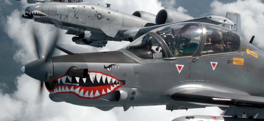 A Colombian Air Force A-29B Super Tucano flies alongside two U.S. Air Force A-10s during Exercise Green Flag East August 2016.