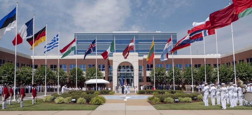 Guests and personnel from NATO’s Allied Command Transformation participate in a U.S. Independence Day Flag Raising ceremony.
