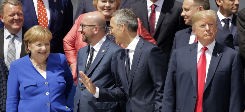 German Chancellor Angela Merkel, Belgian Prime Minister Charles Michel, NATO Secretary-General Jens Stoltenberg and U.S. President Donald Trump, from left, watch a fly-by during a summit at NATO headquarters in Brussels Wednesday, July 11, 2018.
