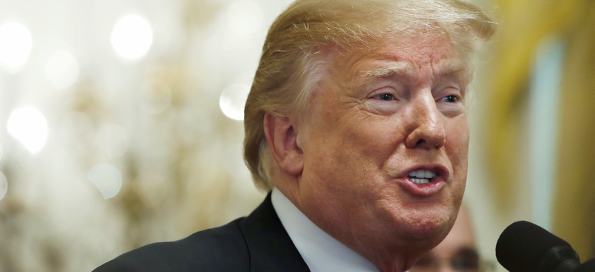 In this June 29, 2018 photo, President Donald Trump gestures while speaking, during an event in the East Room of the White House in Washington.