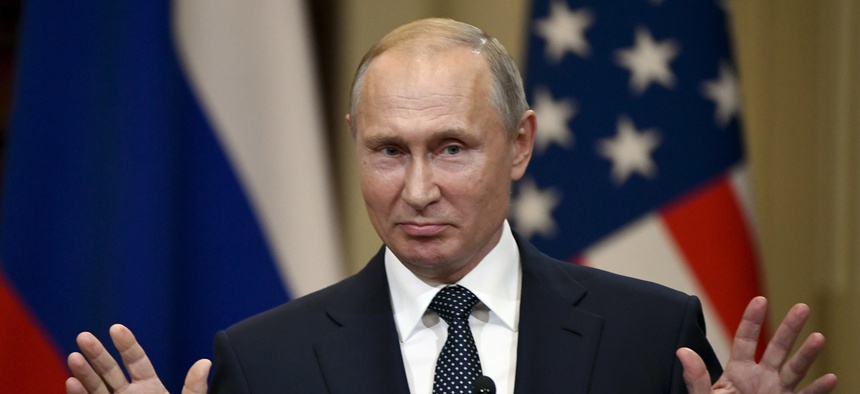 Russian President Vladimir Putin gestures during a joint press conference with U.S. President Donald Trump at the Presidential Palace in Helsinki, Finland, Monday, July 16, 2018.