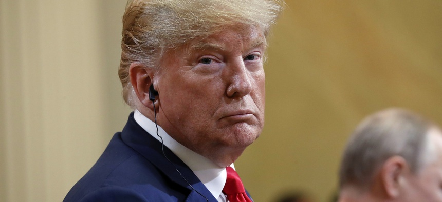 U.S. President Donald Trump, left, looks over as he listens to Russian President Vladimir Putin, right, speak during their joint news conference at the Presidential Palace in Helsinki, Finland, Monday, July 16, 2018.
