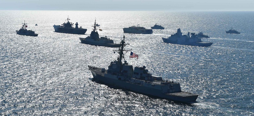 Thirty maritime unit ships from 12 nations maneuver in close formation for a photo exercise during Exercise Baltic Operations (BALTOPS) 2018 in the Baltic Sea.