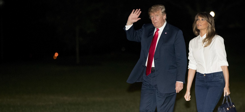 President Donald Trump and first lady Melania Trump walk across the South Lawn of the White House in Washington, Monday, July 16, 2018. Trump returns following a meeting with Russian President Vladimir Putin in Helsinki, Finland.