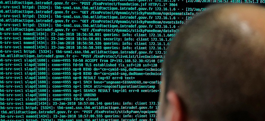 In this Jan.23 2018 file photo, a French solider watches code lines on his computer at the French Defense ministry stand during the International Cybersecurity forum in Lille, northern France.