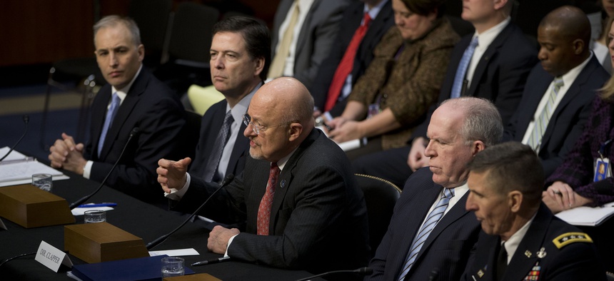 Director of National Intelligence James Clapper, center, testifies on Capitol Hill in Washington, Jan. 29, 2014. From left are, National Counterterrorism Center Director Matthew Olsen, FBI Director James Comey, Clapper, and CIA Director John Brennan.