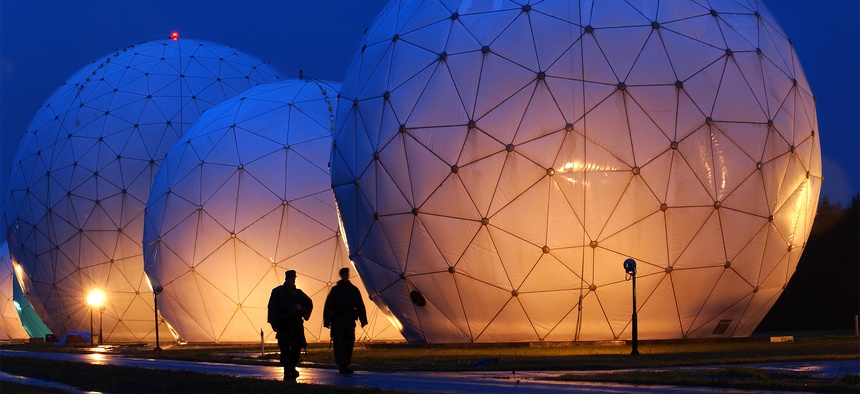 Boatswain's Mate Second Class Donald Rouse and Air Force Airman John Yorde make early morning security rounds by the radomes at the Cryptologic Operations Center, Misawa, Japan.