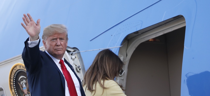 U.S. President Donald Trump waves when boarding Air Force One as he leaves with his wife Melania, right, from the airport in Helsinki, Finland, Monday, July 16, 2018.