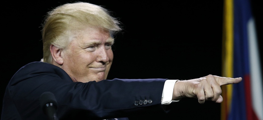 In this July 1, 2016, photo, Republican presidential candidate Donald Trump points to supporters during the opening session of the Western Conservative Summit in Denver.