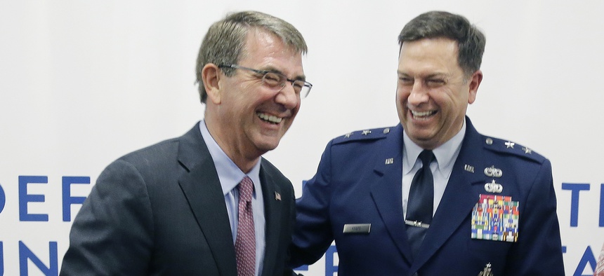Defense Secretary Ash Carter, left, laughs with Major General Gary W. Keefe, July 26, 2016, in Cambridge, Mass. Carter appeared in Cambridge to formally open the second office of DIUx, near the Massachusetts Institute of Technology.