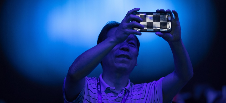 A spectator takes a cellphone photo of the CHAIN Cup at the China National Convention Center in Beijing, Saturday, June 30, 2018.