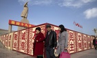 In this Nov. 4, 2017 photo, residents walk past a statue showing Mao Zedong near billboards with the words for "Welcome 19th Congress," "Patriotism" and "Democracy" near a square in Kashgar in Xinjiang, China. In this Nov. 4, 2017 photo, residents walk past a statue showing Mao Zedong near billboards with the words for "Welcome 19th Congress," "Patriotism" and "Democracy" near a square in Kashgar in Xinjiang, China.