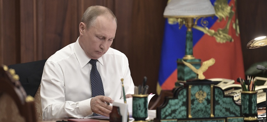 Vladimir Putin sits in his Kremlin cabinet prior his inauguration ceremony as new Russia's president in Moscow, Russia, Monday, May 7, 2018. Putin won the six-year term in March elections where he tallied 77 percent of the vote.