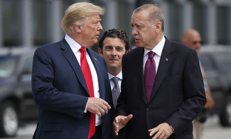  President Donald Trump, left, talks with Turkey's President Recep Tayyip Erdogan, right, as they arrive together for a family photo at a summit of heads of state and government at NATO headquarters in Brussels on Wednesday, July 11, 2018. 