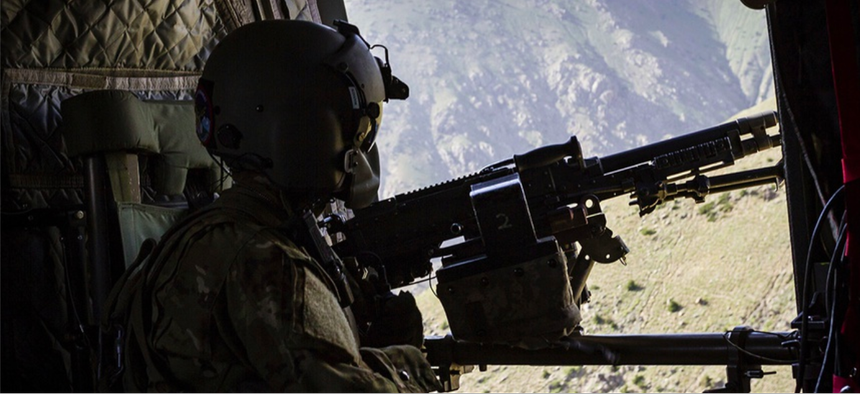 A U.S. Army CH-47 Chinook helicopter crew chief assigned to Task Force Flying Dragons, 16th Combat Aviation Brigade, 7th Infantry Division scans below near Mazar-e-Sharif, Afghanistan.