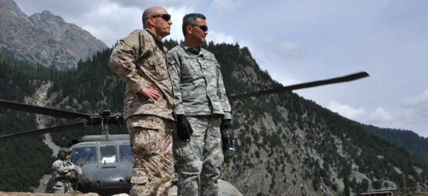 Brig. Gen. Mike Nagata, (left) deputy chief of the Office of the Defense Representative Pakistan and Vice Admiral Mike LeFever, commander of ODRP, watch as relief supplies are offloaded from a U.S. Army UH-60 Black Hawk in Uthror, Pakistan in 2010.