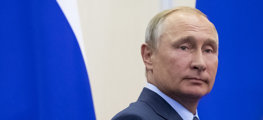 Russian President Vladimir Putin leaves the hall after a joint news conference with Finnish President Sauli Niinisto following their meeting in the Bocharov Ruchei residence in the Black Sea resort of Sochi, Russia, Wednesday, Aug. 22, 2018.