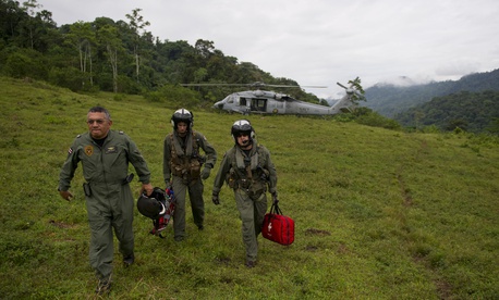 Costa Rica Police Air Patrol Officer Capt. George Lozano, left, Naval Air Crewman 3rd Class Joe Wainscott and Chief Naval Air Crewman Justin Crowe head toward a village to assist an injured boy in Bajo, Blay, Costa Rica, during Continuing Promise 2011. Costa Rica Police Air Patrol Officer Capt. George Lozano, left, Naval Air Crewman 3rd Class Joe Wainscott and Chief Naval Air Crewman Justin Crowe head toward a village to assist an injured boy in Bajo, Blay, Costa Rica, during Continuing Promise 2011.