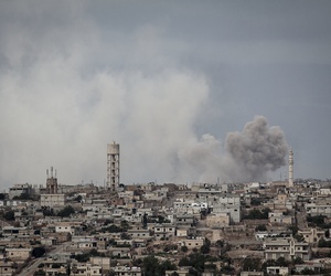 In this Sept. 19, 2013 photo, smoke rises after a TNT bomb was thrown from a helicopter, hitting a rebel position during heavy fighting between troops loyal to president Bashar Assad and opposition fighters, in the Idlib province countryside, Syria. In this Sept. 19, 2013 photo, smoke rises after a TNT bomb was thrown from a helicopter, hitting a rebel position during heavy fighting between troops loyal to president Bashar Assad and opposition fighters, in the Idlib province countryside, Syria.