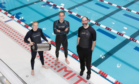 From left, graduate student Anton Cottrill, Dr. Jacopo Buongiorno and Dr. Michael Strano try out their neoprene wetsuits at a pool at MIT’s athletic center. Cottrill is holding the pressure tank used to treat the wetsuits with heavy inert gasses. From left, graduate student Anton Cottrill, Dr. Jacopo Buongiorno and Dr. Michael Strano try out their neoprene wetsuits at a pool at MIT’s athletic center. Cottrill is holding the pressure tank used to treat the wetsuits with heavy inert gasses.