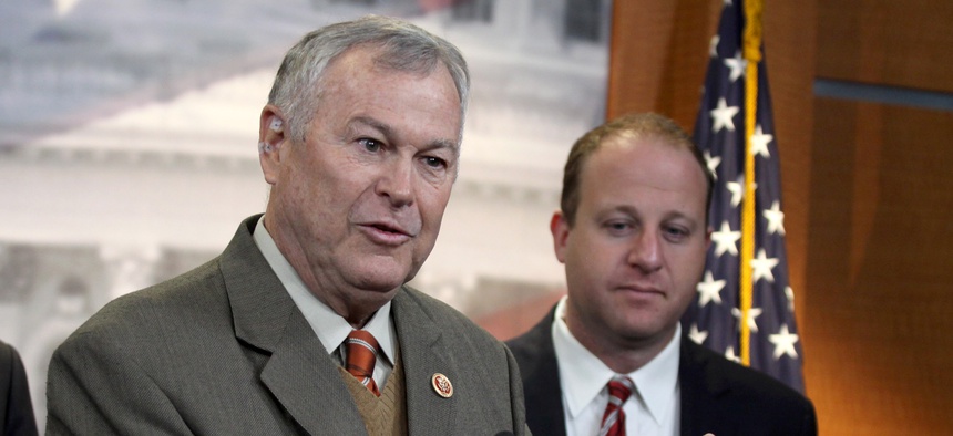 Rep. Dana Rohrabacher, R-Calif., left, accompanied by Rep. Jared Polis, D-Colo., speaks during a news conference on Capitol Hill in Washington, Thursday, Nov, 13, 2014, to discuss marijuana laws.