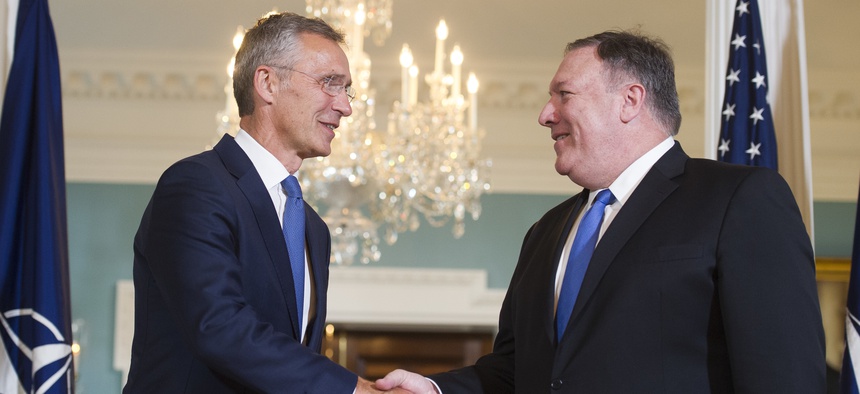 Secretary of State Mike Pompeo, right, shakes hands as he meets with NATO Secretary General Jens Stoltenberg at the State Department in Washington, Thursday, Sept. 13, 2018.