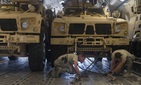 Tech. Sergeants Josiah Bourke and Nick Akins, 332nd Expeditionary Logistics Readiness Squadron air transportation specialists, secure mine-resistant ambush protected vehicles for transportation in Southwest Asia March 7, 2018.