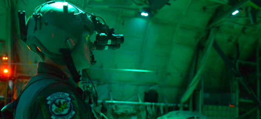 A U.S. Air Force loadmaster uses night vision goggles during a night flight over Bulgaria, July 15, 2018.