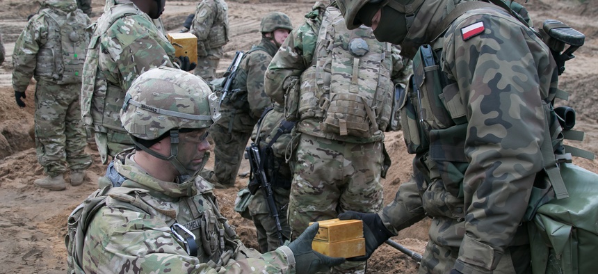 Troops assigned to the Polish Army's 2nd Engineer Battalion, 5th Engineer Regiment and the U.S. Army's 82nd Brigade Engineer Battalion, 2nd Armored Brigade Combat Team, 1st Infantry Division train together near Oleszno, Poland Nov. 27, 2017.