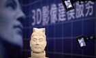Video cameras scan a replica of a terra-cotta warrior figure at the 21st China Beijing International High-tech Expo in Beijing, China, Friday, May 18, 2018. The annual expo is a showcase of China's state-of-the-art technologies and cutting-edge ideas.