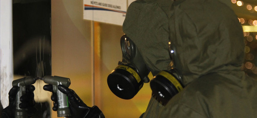 A Hazmat crew checks a stain on the wall at Kuala Lumpur International Airport 2 in Sepang, Malaysia on Sunday, Feb. 26, 2017.