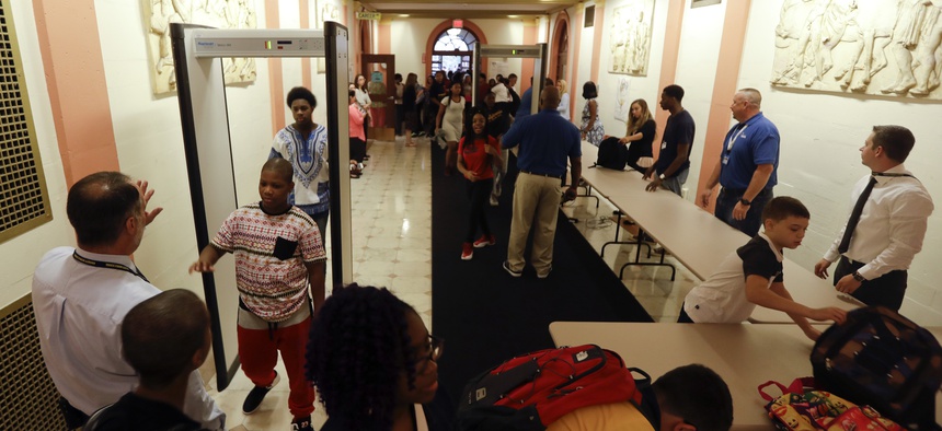 Students at William Hackett Middle School pass through metal detectors on the first day of school on Tuesday, Sept. 6, 2016, in Albany, N.Y.