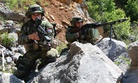 Two Croatian soldiers from 1st Platoon, 1st Company, Tiger Battalion, take cover and provide security as their platoon conducts a movement to contact exercise during the Immediate Response 2012 (IR12) training event held in Croatia on May 29, 2012.