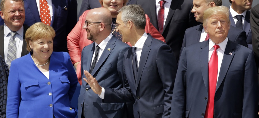 German Chancellor Angela Merkel, Belgian Prime Minister Charles Michel, NATO Secretary-General Jens Stoltenberg and U.S. President Donald Trump, from left, watch a fly-by during a summit of heads of state and government in Brussels July 11, 2018.