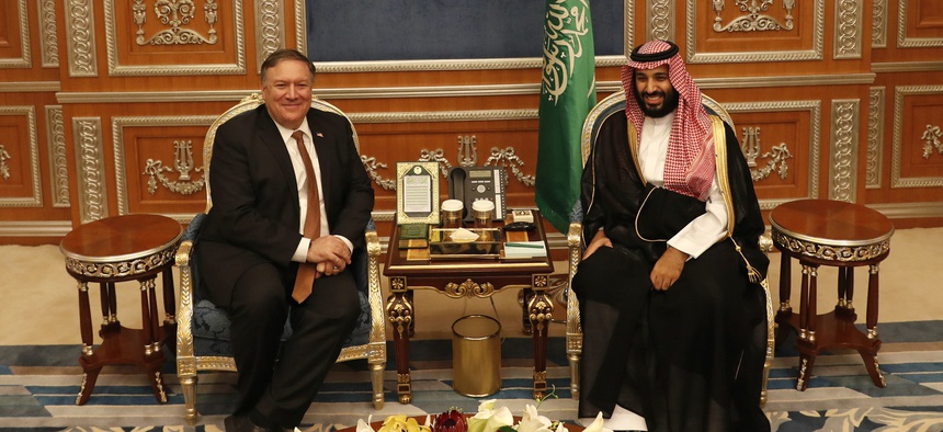 U.S. Secretary of State Mike Pompeo meets with the Saudi Crown Prince Mohammed bin Salman under a portrait of Saudi King Salman, in Riyadh, Saudi Arabia, Tuesday Oct. 16, 2018.