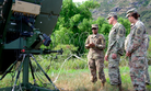Sgt. Patricia Donaldson, a military systems maintainer/integrator assigned to 715th Military Intelligence Battalion, briefs colleagues on communications equipment during training exercise Lightning Forge on the Island of Oahu July 24, 2018.