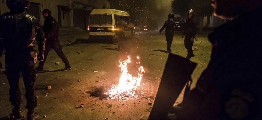 Riot police patrol in the streets of Tebourba, south of the Tunisian capital, Tunis, during anti-government protests, Tuesday, Jan. 9, 2018.