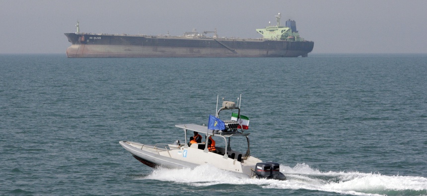 In this July 2, 2012 file photo, an Iranian Revolutionary Guard speedboat moves in the Persian Gulf while an oil tanker is seen in background.