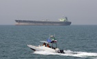 In this July 2, 2012 file photo, an Iranian Revolutionary Guard speedboat moves in the Persian Gulf while an oil tanker is seen in background. In this July 2, 2012 file photo, an Iranian Revolutionary Guard speedboat moves in the Persian Gulf while an oil tanker is seen in background.