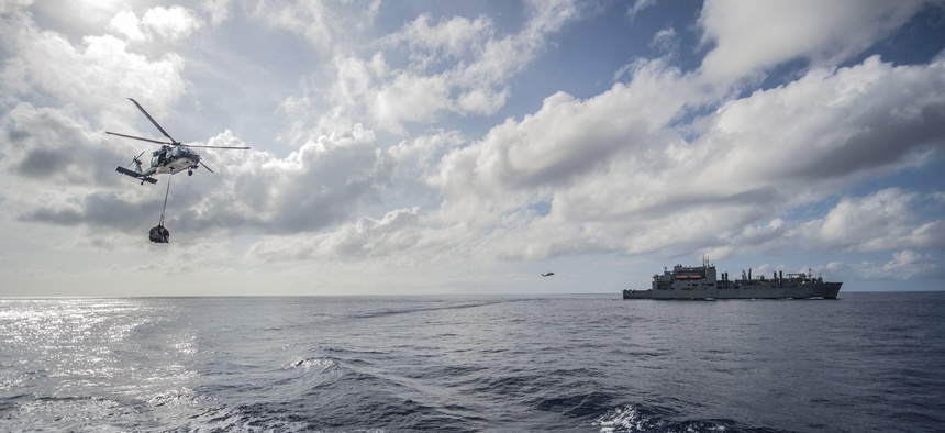 Military Sealift Command fleet replenishment oiler USNS John Ericsson (T-AO 194) and MH-60S Seahawk helicopters from the Island Knights of Helicopter Sea Combat Squadron (HSC) 25 participate in an exercise in the South China Sea, Oct. 20, 2014.