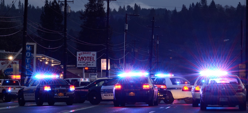 Police cars at incident where a person who shot at officers and then barricaded himself in a hotel in Roseburg Oregon, December 17, 2012.