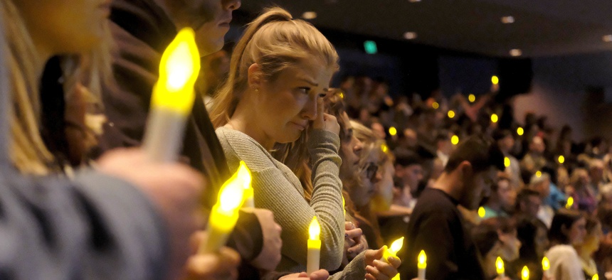 People gather to pray for the victims of a mass shooting during a candlelight vigil in Thousand Oaks, Calif., Thursday, Nov. 8, 2018.