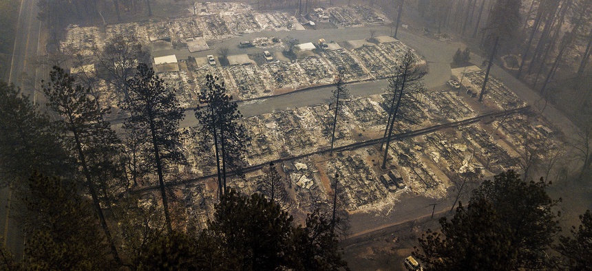In this Nov. 15, 2018, file photo, residences leveled by the wildfire line a neighborhood in Paradise, Calif.