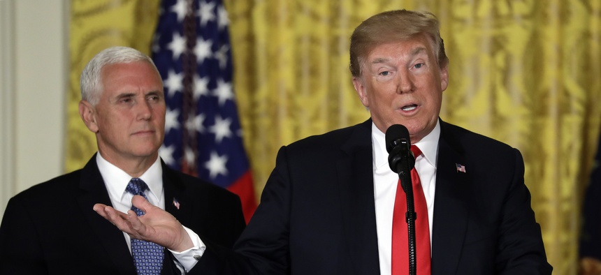 President Donald Trump speaks at a June 2018 meeting of the National Space Council, which is led by Vice President Mike Pence, left.