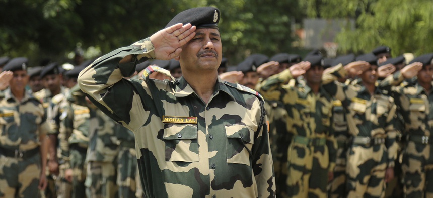 Indian Border Security Force soldiers pay tribute to two colleagues during a wreath-laying ceremony at the BSF headquarters in Jammu, India, Sunday, June. 3, 2018.