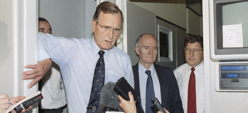 President George Bush speaks to reporters aboard Air Force One, June 1, 1991 to praise the U.S.-Soviet accord on reducing non-nuclear weapons in Europe.