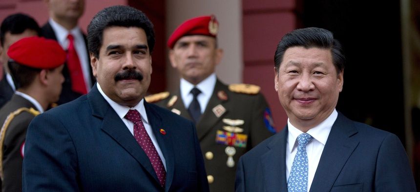 China's President Xi Jinping, right, shakes hand of Venezuela's President Nicolas Maduro, left, prior their meeting at Miraflores Presidential palace in Caracas, Venezuela, Sunday, July 20, 2014.