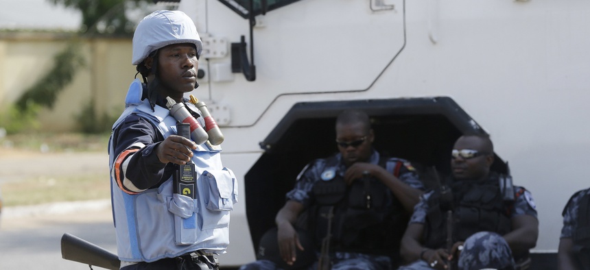 Police officers guard the entrance of Ghana electoral commission office in Accra Ghana, Friday, Dec. 9, 2016.