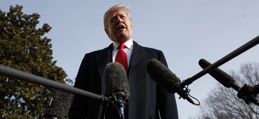 President Donald Trump talks to media before boarding Marine One on the South Lawn of the White House in Washington, Saturday, Dec. 8, 2018.